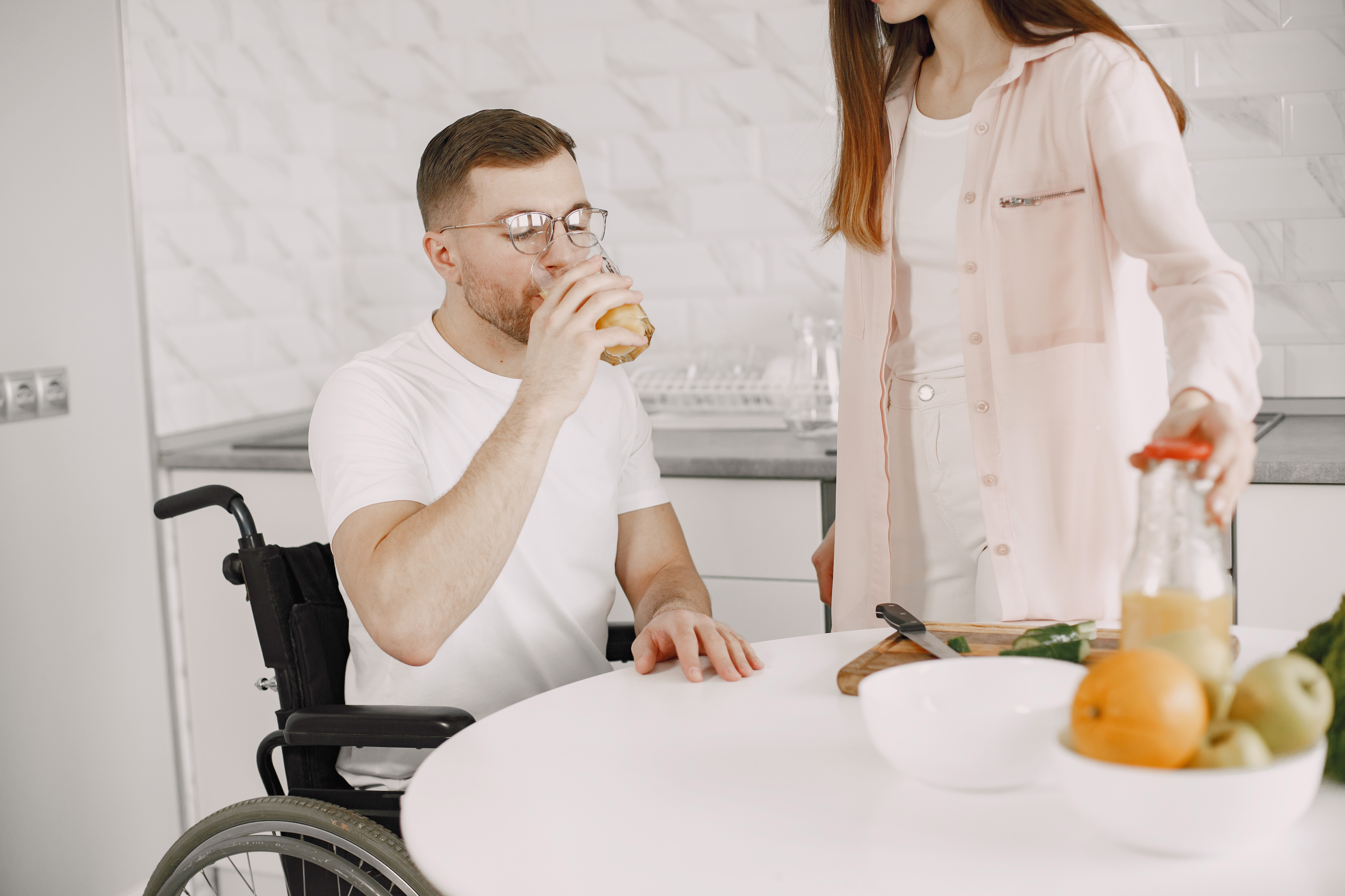 Woman With Disabled Man Wheelchair Having Breakfast Together Home